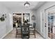 Bright dining room with a round table and four chairs, offering access to the kitchen and patio at 7146 Territory Ln, Sarasota, FL 34240