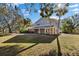 Side view of two-story home with landscaped yard at 7146 Territory Ln, Sarasota, FL 34240