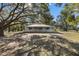 House exterior showcasing a metal roof and a large front yard at 7146 Territory Ln, Sarasota, FL 34240