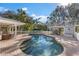 Relaxing kidney-shaped pool with patio and outdoor furniture at 7146 Territory Ln, Sarasota, FL 34240