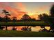 Gorgeous sunset reflecting in a pond on a verdant golf course, showing vibrant colors at 7461 W Country Club Dr. N N # 106, Sarasota, FL 34243