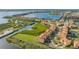 Aerial view highlighting a waterfront townhouse community with lush landscaping and a canal at 1309 3Rd Street E Cir, Palmetto, FL 34221