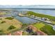 An aerial view showcasing a waterfront townhouse with a private driveway and canal views at 1309 3Rd Street E Cir, Palmetto, FL 34221