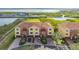 Aerial view of three-story townhouses with attached garages and a community setting at 1309 3Rd Street E Cir, Palmetto, FL 34221