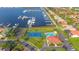 Aerial view showing community pool, tennis court, marina, and homes at 1309 3Rd Street E Cir, Palmetto, FL 34221