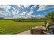 Relaxing patio with fire pit overlooking a lush green landscape at 1309 3Rd Street E Cir, Palmetto, FL 34221