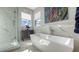 Luxury bathroom with marble tile, soaking tub, and walk-in shower at 1309 3Rd Street E Cir, Palmetto, FL 34221