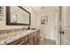 Modern bathroom with granite countertop and wood cabinets at 1309 3Rd Street E Cir, Palmetto, FL 34221