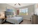 Cozy bedroom with wood floors and large window at 1309 3Rd Street E Cir, Palmetto, FL 34221