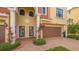 Townhouse entryway with double doors, attached garage, and Mediterranean-inspired design at 1309 3Rd Street E Cir, Palmetto, FL 34221