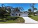 Charming single-story home with a well-manicured lawn and a two-car garage at 1859 Lamont St, North Port, FL 34288