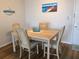 Condo dining area with a wood table and four chairs at 3006 Caring Way # 409, Port Charlotte, FL 33952