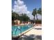 Community pool with lounge chairs and surrounding landscaping at 3006 Caring Way # 409, Port Charlotte, FL 33952