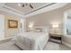 Cozy bedroom featuring a queen-sized bed, tray ceiling, and natural light from the shuttered window at 4611 Trento Pl, Bradenton, FL 34211