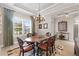 Formal dining room with a large table, stylish chandelier, and a window with a view of the outdoors at 4611 Trento Pl, Bradenton, FL 34211