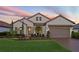 Charming single-Gathering home featuring well-manicured lawn and landscaping with a two-car garage and tile roof at 4611 Trento Pl, Bradenton, FL 34211