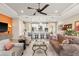 Bright and airy living room featuring a brown velvet sofa, modern ceiling fan, and open-concept kitchen at 4611 Trento Pl, Bradenton, FL 34211