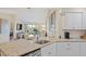 Modern kitchen with granite countertops and white cabinets at 6059 Bahia Del Mar Blvd # 239, St Petersburg, FL 33715