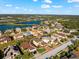 Aerial view of a house with a pool and screened enclosure in a residential neighborhood at 6614 38Th E St, Sarasota, FL 34243