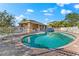 Community pool with a covered patio and lounge chairs at 6614 38Th E St, Sarasota, FL 34243