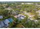 Aerial view of single-Gathering home with solar panels, pool, and lush landscaping at 6623 Glades Way, Sarasota, FL 34231