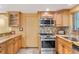 Light wood kitchen cabinets, granite countertops, stainless steel appliances at 6623 Glades Way, Sarasota, FL 34231