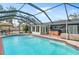 Large swimming pool with a screened enclosure at 6623 Glades Way, Sarasota, FL 34231