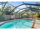 Inviting swimming pool with screened enclosure at 6623 Glades Way, Sarasota, FL 34231