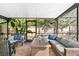 Relaxing screened patio with wicker furniture and a view of the backyard at 6623 Glades Way, Sarasota, FL 34231