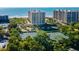 Aerial view of condo complex with tennis courts and ocean views at 1211 Gulf Of Mexico Dr # 706, Longboat Key, FL 34228