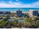 Aerial view of oceanfront condo building with tennis courts at 1211 Gulf Of Mexico Dr # 706, Longboat Key, FL 34228