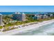 Aerial view of beachfront condos, pool, and white sand beach at 1211 Gulf Of Mexico Dr # 706, Longboat Key, FL 34228