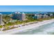 Aerial view of beachfront condo building with pool and tennis courts at 1211 Gulf Of Mexico Dr # 706, Longboat Key, FL 34228