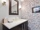 Vanity with modern fixtures and patterned wall at 1211 Gulf Of Mexico Dr # 706, Longboat Key, FL 34228