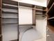 Large walk-in closet with custom built-in shelving and hanging rods at 1211 Gulf Of Mexico Dr # 706, Longboat Key, FL 34228