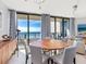 Dining area with ocean view, round wooden table at 1211 Gulf Of Mexico Dr # 706, Longboat Key, FL 34228