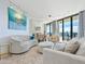 Living room with ocean view, comfy seating and art at 1211 Gulf Of Mexico Dr # 706, Longboat Key, FL 34228