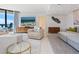 Bright living room with ocean views, comfy seating, and large TV at 1211 Gulf Of Mexico Dr # 706, Longboat Key, FL 34228