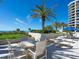 Seating area with ocean views and palm trees at 1211 Gulf Of Mexico Dr # 706, Longboat Key, FL 34228