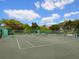 Two well-maintained tennis courts surrounded by lush greenery at 1211 Gulf Of Mexico Dr # 706, Longboat Key, FL 34228