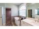 Spa-like bathroom with a large soaking tub and a walk-in shower at 13634 7Th Avenue Ne Cir, Bradenton, FL 34212