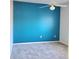 Bedroom with teal feature wall and grey carpet at 13634 7Th Avenue Ne Cir, Bradenton, FL 34212