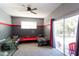 Spacious bedroom with red and gray accents, twin beds, and backyard access at 13634 7Th Avenue Ne Cir, Bradenton, FL 34212