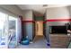 Bedroom with gray and red walls, sliding glass doors, and a tv stand at 13634 7Th Avenue Ne Cir, Bradenton, FL 34212