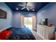 Main bedroom with blue walls and sliding glass doors at 13634 7Th Avenue Ne Cir, Bradenton, FL 34212