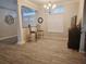 Open dining area with wood-look tile flooring and a view to the living room at 13634 7Th Avenue Ne Cir, Bradenton, FL 34212