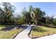 Landscaped backyard with a fire pit and a winding pathway at 13634 7Th Avenue Ne Cir, Bradenton, FL 34212