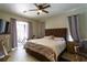 Large main bedroom with a king-size bed and access to the back patio at 13634 7Th Avenue Ne Cir, Bradenton, FL 34212