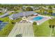 Community pool, shuffleboard courts, and clubhouse with surrounding landscape at 4009 38Th Avenue W Dr # 4009, Bradenton, FL 34205