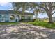 House with driveway and large tree in front at 4009 38Th Avenue W Dr # 4009, Bradenton, FL 34205